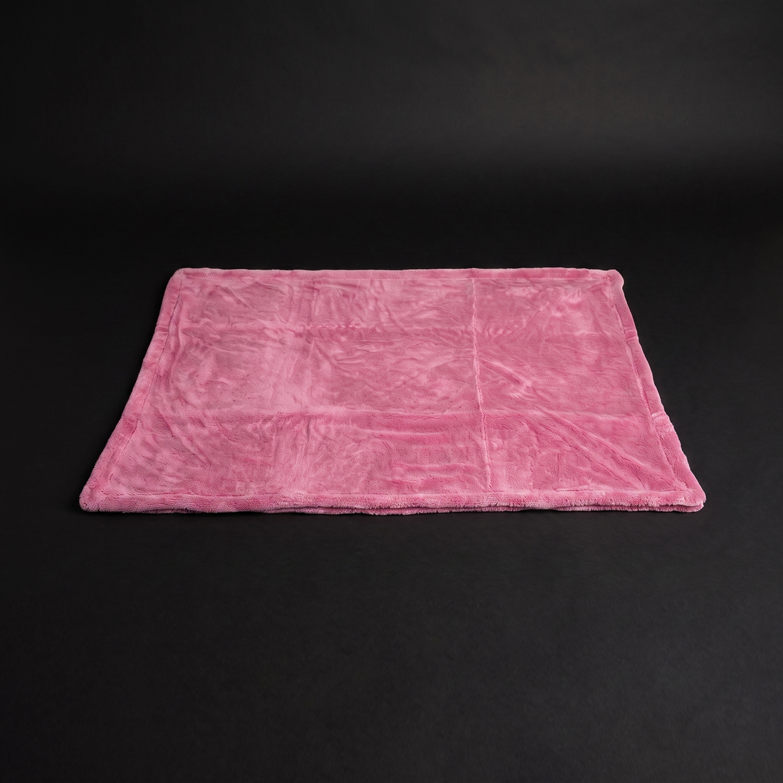 pink drying towel flat lay